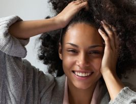 Beautiful Woman Smiling With Hands In Hair