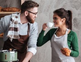 Cheerful Loving Couple Bakers Drinking Coffee